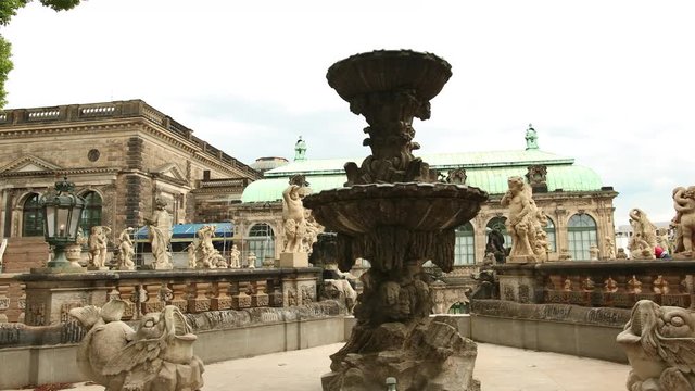 Closeup stone statue of child faunus at Zwinger palace in Dresden, Germany. Wide angle, prores, slow motion