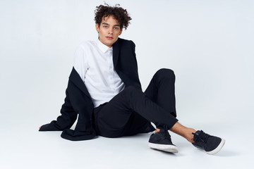 young man sitting on the floor with laptop