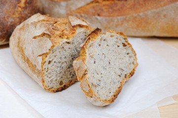 Freshly baked hommade organic bread in rustic setting. Bakery. Close-up on traditional bread.