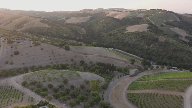 Aerial Drone Shot of a House in a Valley Surrounded by Vineyards During Sunset (Paso Robles,California)