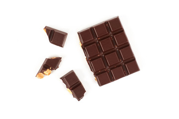 bar of dark chocolate with hazelnuts. Pieces of chocolate with nuts, isolated on white background.