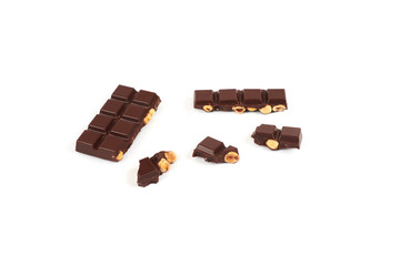 bar of dark chocolate with hazelnuts. Pieces of chocolate with nuts, isolated on white background.