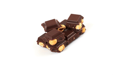 Chocolate pieces with nuts isolated on white background