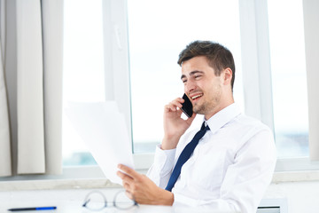 businessman talking on phone in his office