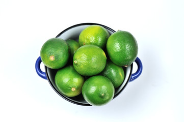 Lime Citrus Fruits in a bowl over white background