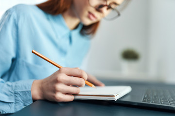 young woman writing in notebook