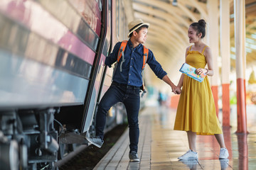 Couple of tourists near the train. Travelling together by train.