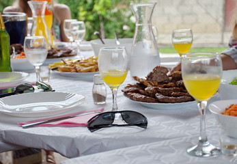 Food and drink on a table in the backyard