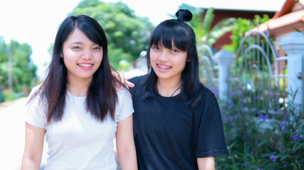 Portrait of two sister walking and smile on the street