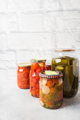 Preservation of vegetables in banks. Fermentation products. Harvesting cucumbers and tomatoes for the winter. Copy space