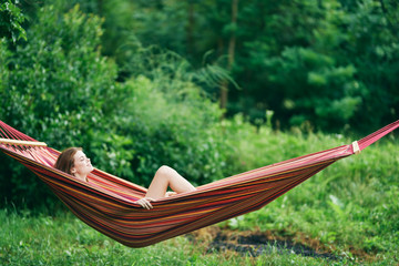young woman relaxing in hammock