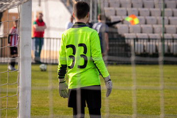 Young goalkeeper is waiting.