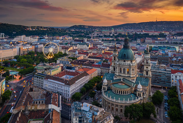 Fototapeta na wymiar Budapest, Hungary - Aerial skyline view of Budapest at sunset with St.Stephen's Basilica. Buda Castle Royal palace and ferris wheel at background at the downtown of Pest