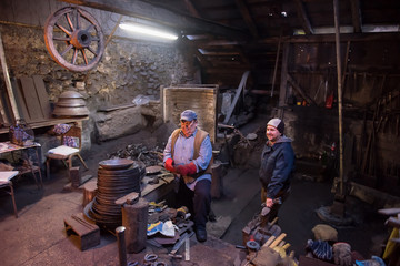 portrait of two generations traditional blacksmith