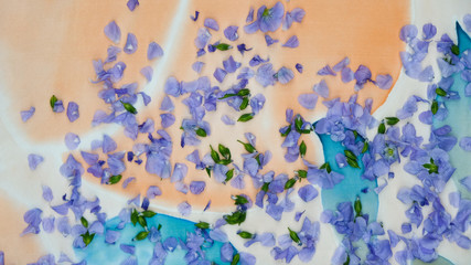  Delicate petals of flax on the batik surface. Flower background. 