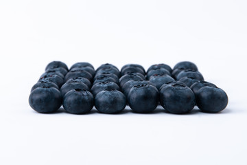 Fresh and raw blueberries - Delicious ripe blueberries - Thirty-six blueberries lined up on a white background