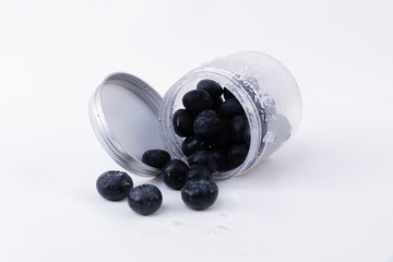 A jar full of cold blueberries - Cold and sweet isolated blueberries on a white background