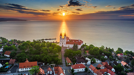 Tihany, Hungary - Aerial skyline view of the famous Benedictine Monastery of Tihany (Tihany Abbey) with beautiful colourful sky and clouds at sunrise over Lake Balaton