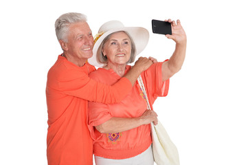 Senior couple taking selfie isolated on white background