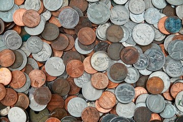 A collage of coins of all different American currency.