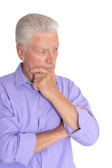 Thinking senior man isolated on white background