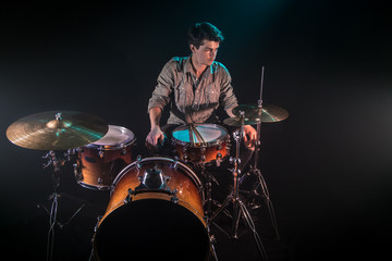 Fototapeta na wymiar musician playing drums, black background and beautiful soft light