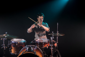 Fototapeta premium musician playing drums, black background and beautiful soft light