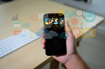 double exposure of business man hand working on laptop computer on wooden desk with social media network diagram.