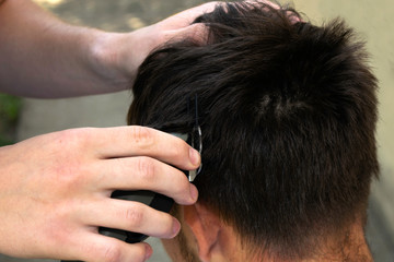 a barber cuts the guy off with a clipper