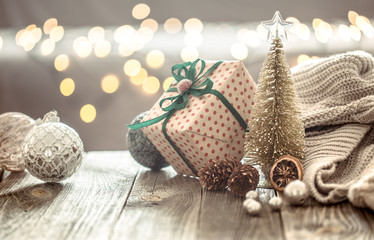 Christmas tree decorations over Christmas lights bokeh in home on wooden table with sweater on a background and decorations. Holiday decoration