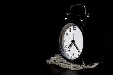 Classic mechanical alarm clock on dark background. Low key