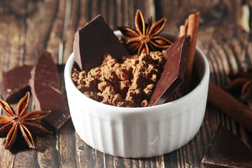 Cocoa powder and a bar of dark chocolate