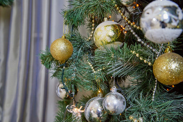 Christmas tree branch decorated with beautiful shiny balls