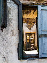Abandoned and dilapidated ruined house with a view through the window, Lost Place