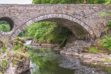 Fototapeta na wymiar three arch bridge which spans the River Teifi at Cenarth, Carmarthenshire in Wales