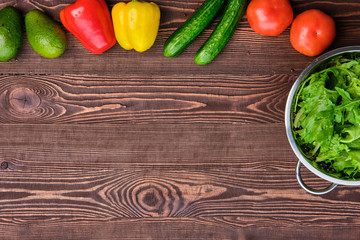 Fresh vegetables on wooden table, view from above, place for text