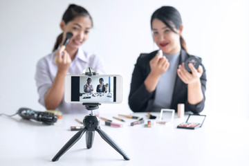 Business online on social media, Two Beautiful Woman Blogger is showing present tutorial beauty...