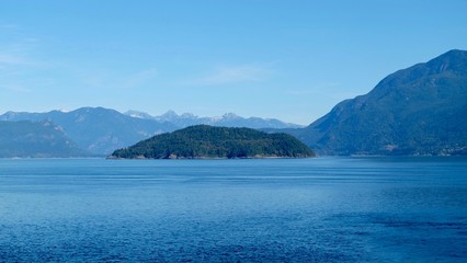 sea and island in front of mountain range