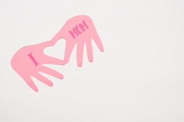 Handmade recycled craft blue card paper in hand shape with heart inside with text I love mom from Asian kid child daughter for mommy in Mother's day holiday isolated on white background