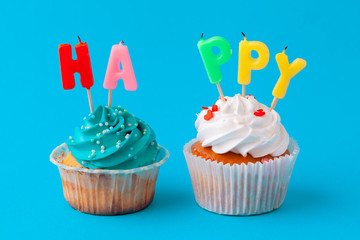 Happy birthday cupcakes on bright colored background