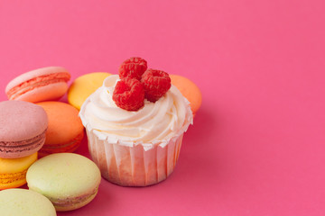 Yummy sweet cupcakes on light pink background