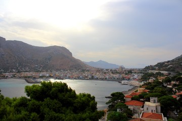 Fototapeta premium evocative image of maritime coast at sunset with fishing village in the background in Sicily, Italy