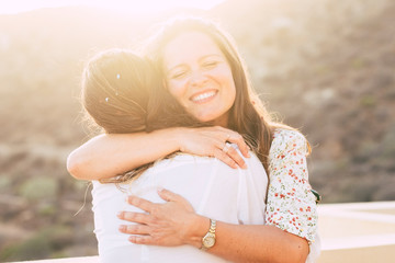 Love and friendship concept twith couple of women young friends hugging and smiling with love -...