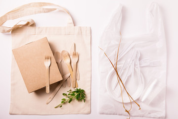 Set of Eco friendly reusable bamboo cutlery and bag and plastic waste on white background. Top view...