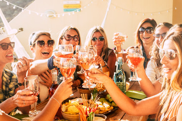 People having fun in friendship - group of cheerful happy caucasian young women laugh and smile together clinking and toasting with red wine during celebration - friends and youthful females - obrazy, fototapety, plakaty