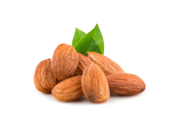 Group of almonds with leaves isolated on white background