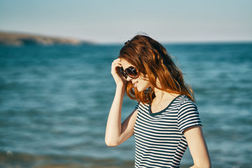 young woman taking photo on the beach