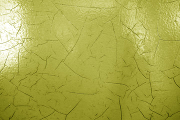 Cracked paint texture in yellow color.