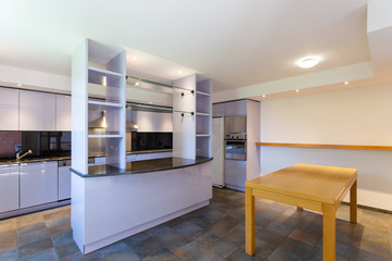 Modern lilac kitchen in luxury loft with modern appliances
