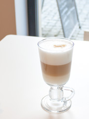 Coffee Latte in glass with great white foam.